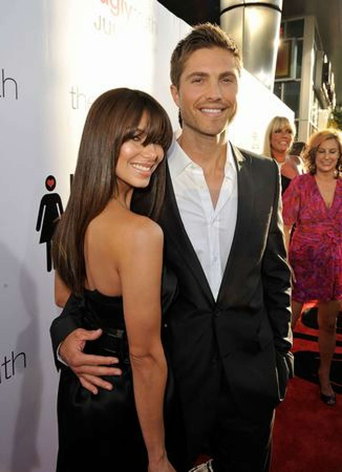 Actress Roselyn Sanchez (L) and actor Eric Winter arrive at the premiere of Columbia Pictures' "The Ugly Truth" held at Pacific's Cinerama Dome in Hollywood, California.