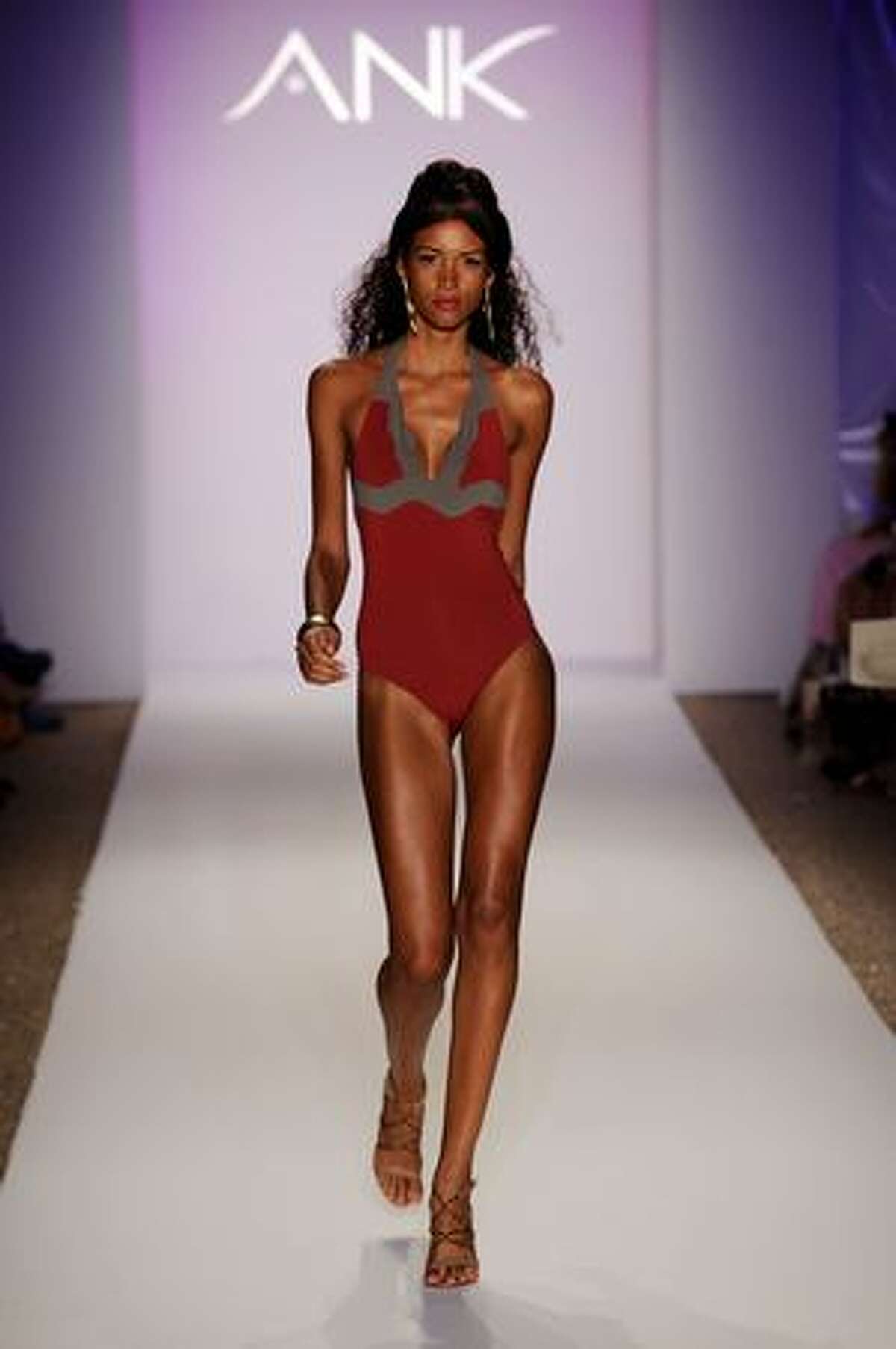 MIAMI BEACH, FL - JULY 17: A model walks the runway at the ANK by Mirla Sabino 2010 fashion show during Mercedes-Benz Fashion Week Swim at the Beachway at The Raleigh on July 17, 2009 in Miami Beach, Florida.