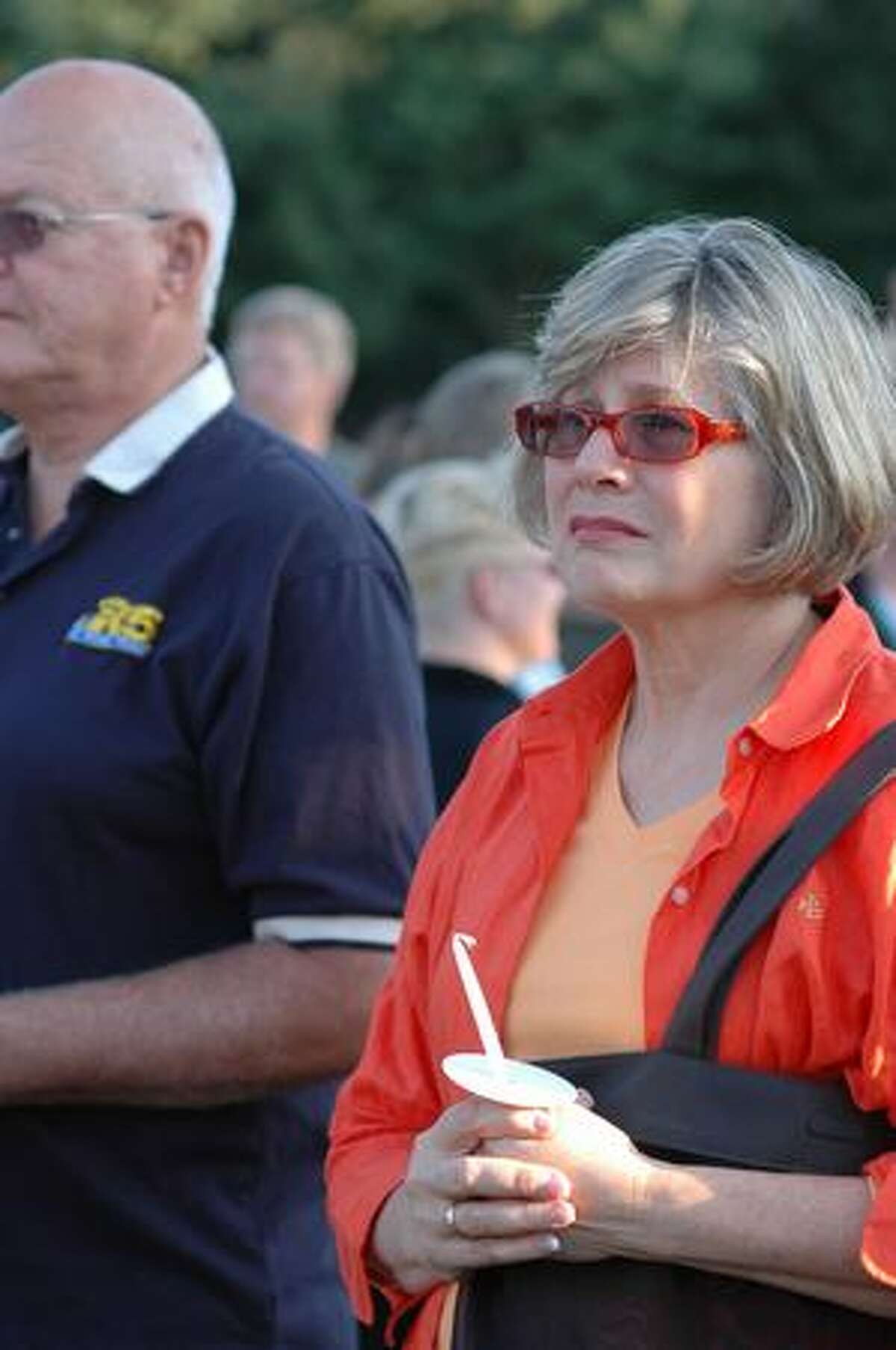 Elizabeth Graham, right, and Bob Cronn watch the start of a candle light vigil for the victim of a stabbing early last week at the South Park Community Center in south Seattle Thursday July 23, 2009. Said Graham, "I am here because this is a tragedy." Photo by Daniel Berman/SeattlePI.com