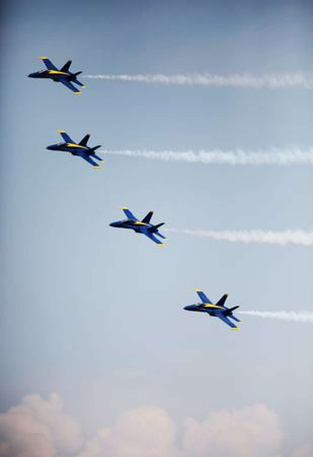 The U.S. Navy Blue Angels demonstration team fly their Boeing F/A-18 Hornets over Lake Washington during a practice on Thursday in Seattle
