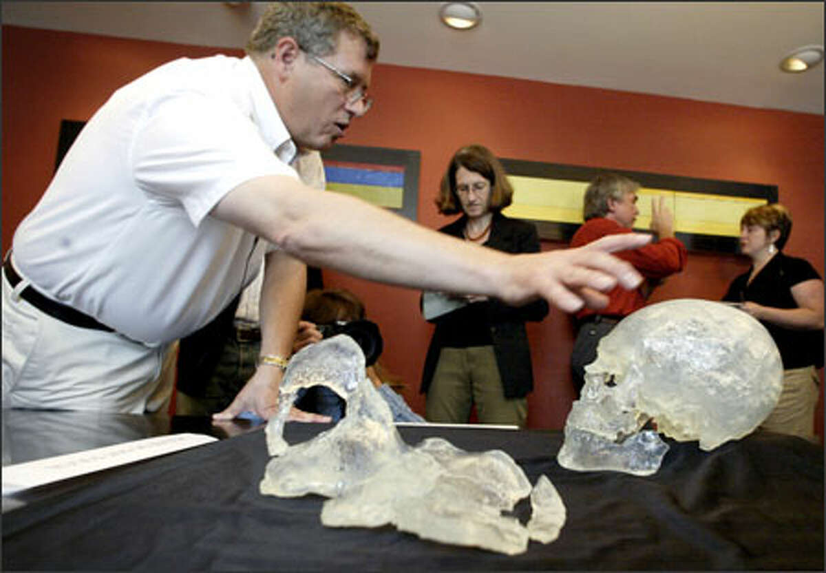Douglas Owsley uses replicas of Kennewick Man's skull and pelvis bone to explain the 11-person scientific team's study of the 9,300-year-old bones in this July 2005 file photo.