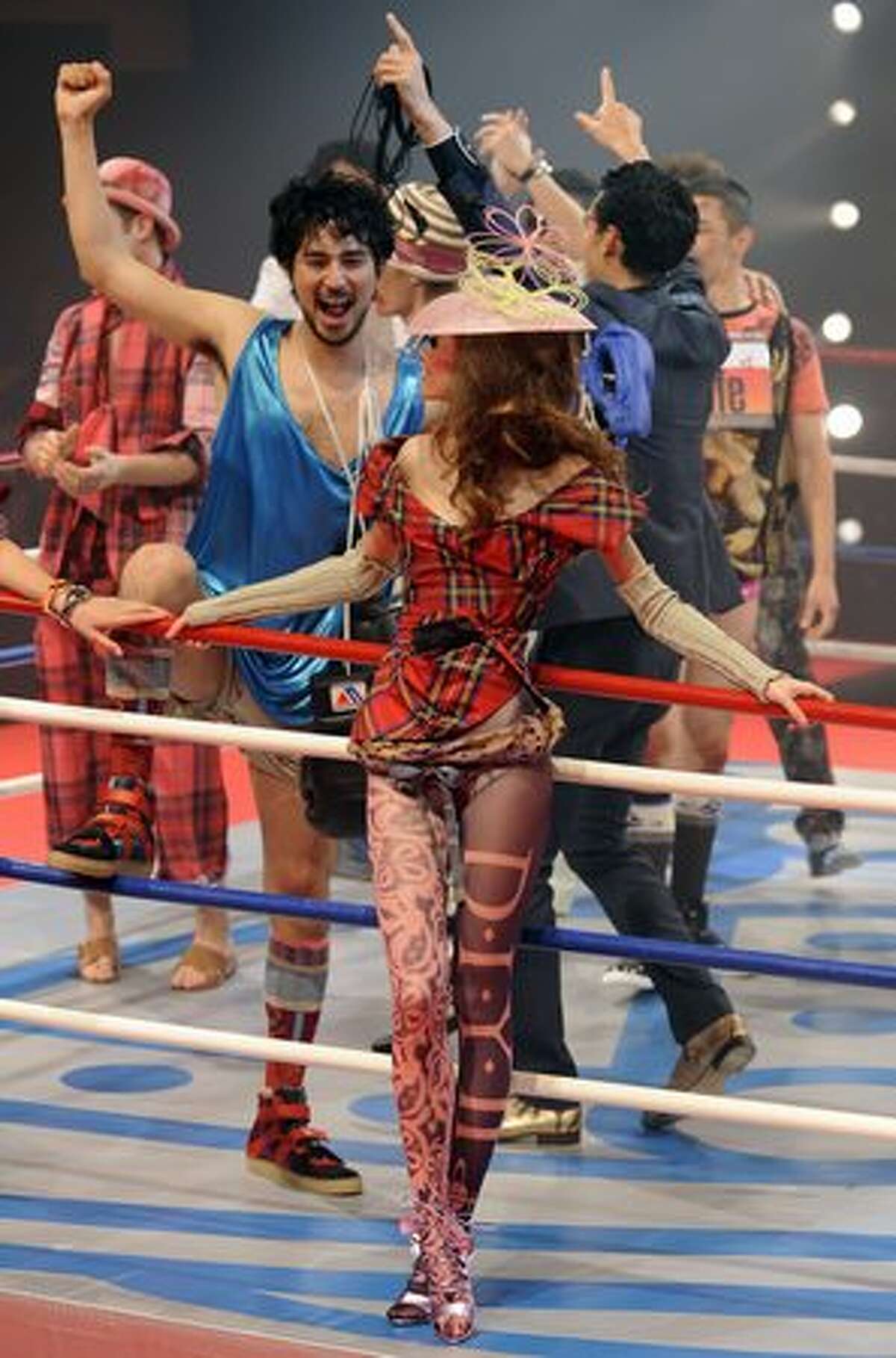 Models celebrate the finale of the fashion show of British designer Vivienne Westwood at a boxing stadium in Tokyo.