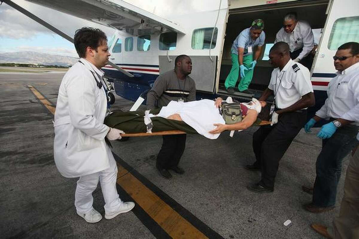 An injured women is prepared for air transport at the Port-au-Prince International airport on Jan. 13, 2010 in Port-au-Prince, Haiti.