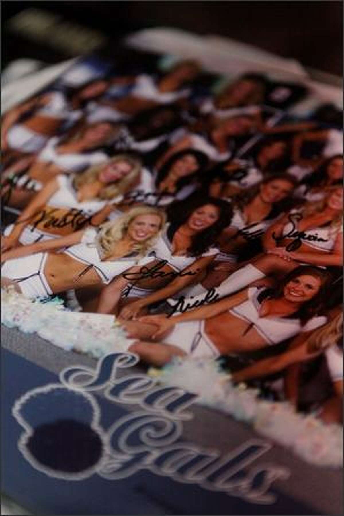Signed 2008 Sea Gals posters rested on a table during the Sea Gals auditions at the Qwest Field West Club Lounge on Sunday.