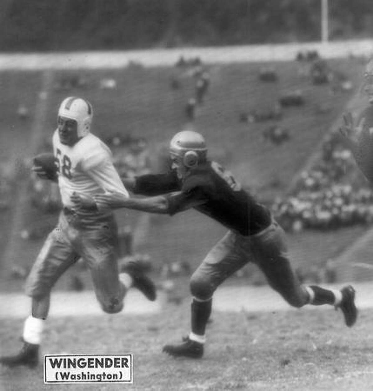 John Wingender (58) Washington halfback, speeds on his way for a gain against California. The Oct. 1945 game was in Berkeley.