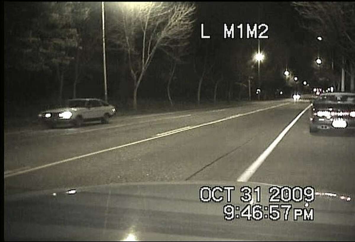 A Datsun sought by police, at left, shown 20 minutes before the fatal Oct. 31 shooting of Officer Tim Brenton. The image was captured by Brenton's patrol car during a traffic stop on Martin Luther King Jr Way near East Jefferson. Brenton and his partner, Britt Sweeney, were discussing a traffic stop conducted on 29th Avenue when the suspect opened fire. (Seattle Police Department photo)