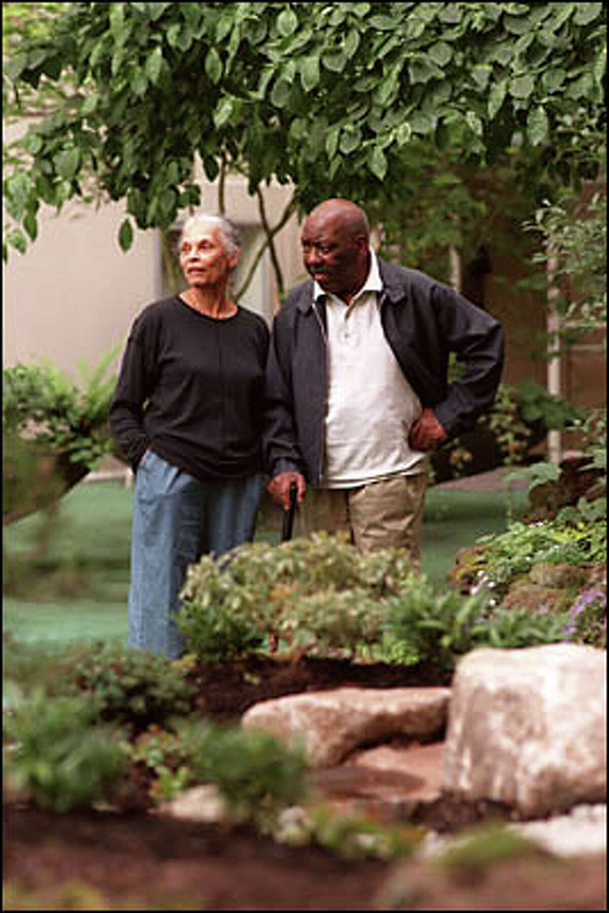 Jacob Lawrence and his wife Gwen Knight saunter through the Horizon House gardens. They married 57 years ago.