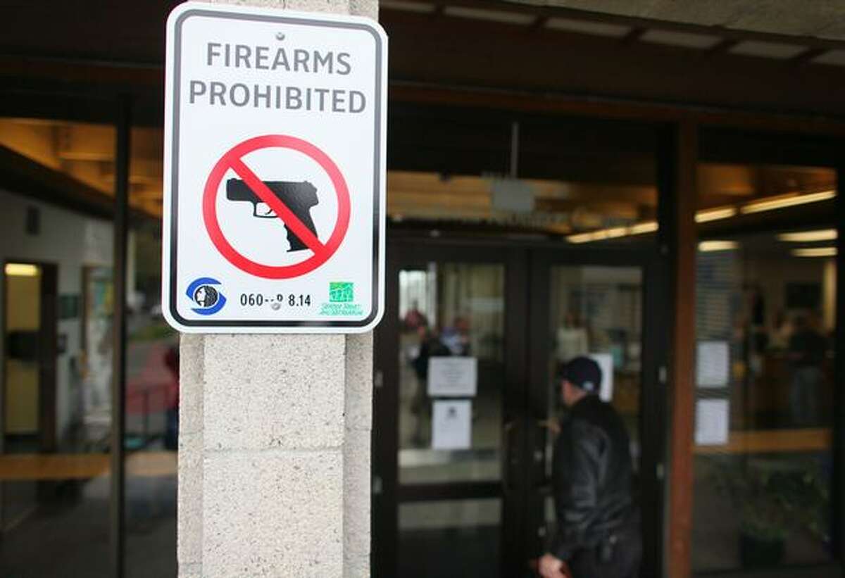 Bob Warden, bottom right, enters Southwest Community Center on Saturday November 14, 2009 in Seattle, while carrying a concealed handgun. He walked into the city-owned building to begin his legal challenge to the City of Seattle's ban on firearms on city property.
