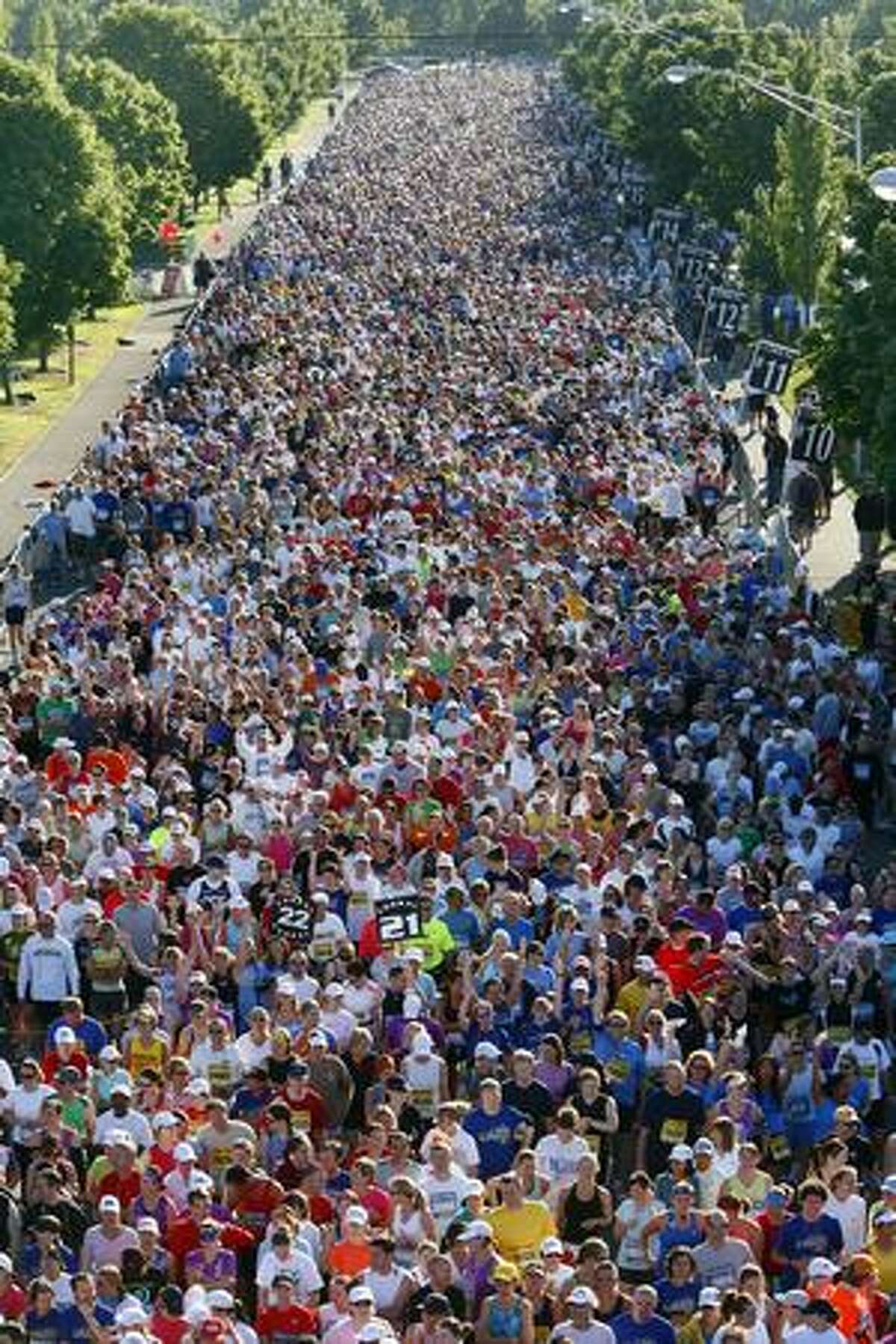 Some of the estimated 25,000 people who signed up for the inaugural Rock 'N' Roll Seattle Marathon gather at the start line in Tukwila on Saturday June 27, 2009.