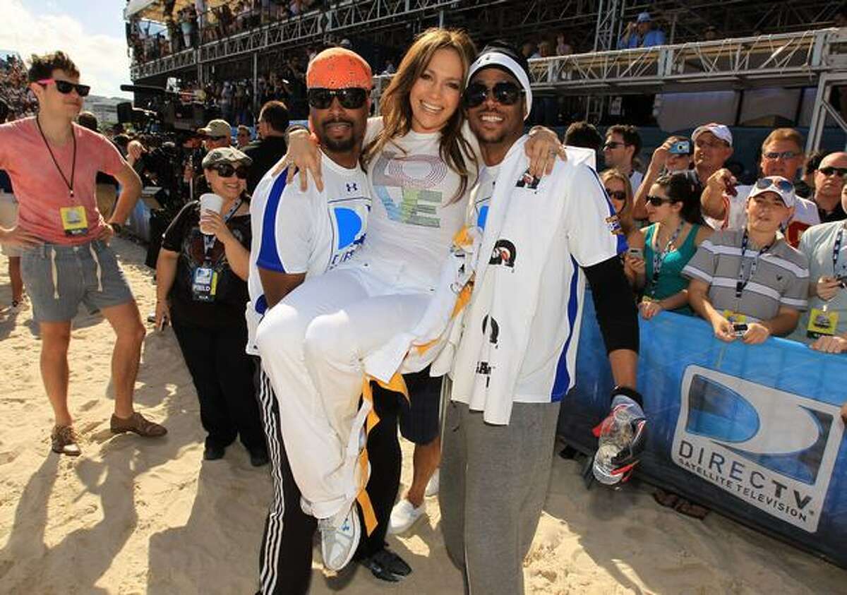 Singer Jennifer Lopez (center) with Shawn Wayans and Marlon Wayans attend the Fourth Annual DIRECTV Celebrity Beach Bowl at DIRECTV Celebrity Beach Bowl Stadium: South Beach on February 6, 2010 in Miami Beach, Florida.