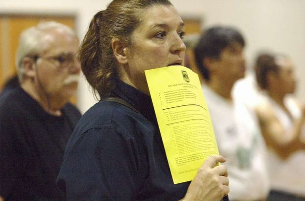 Barbara Apodaca, who has lived in the South Park area almost eight years, listens during a public meeting at the South Park Community Center to discuss the stabbing of an area resident.