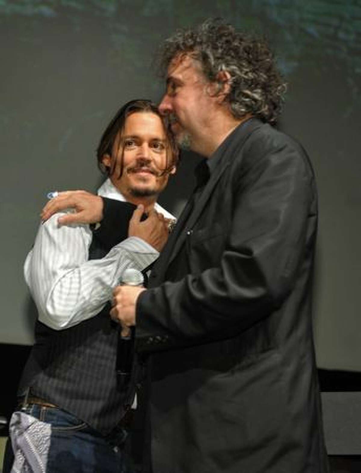 (L-R) Actor Johnny Depp and director Tim Burton speak at "Alice in Wonderland" press conference during Comic-Con 2009 held at San Diego Convention Center in San Diego, California.