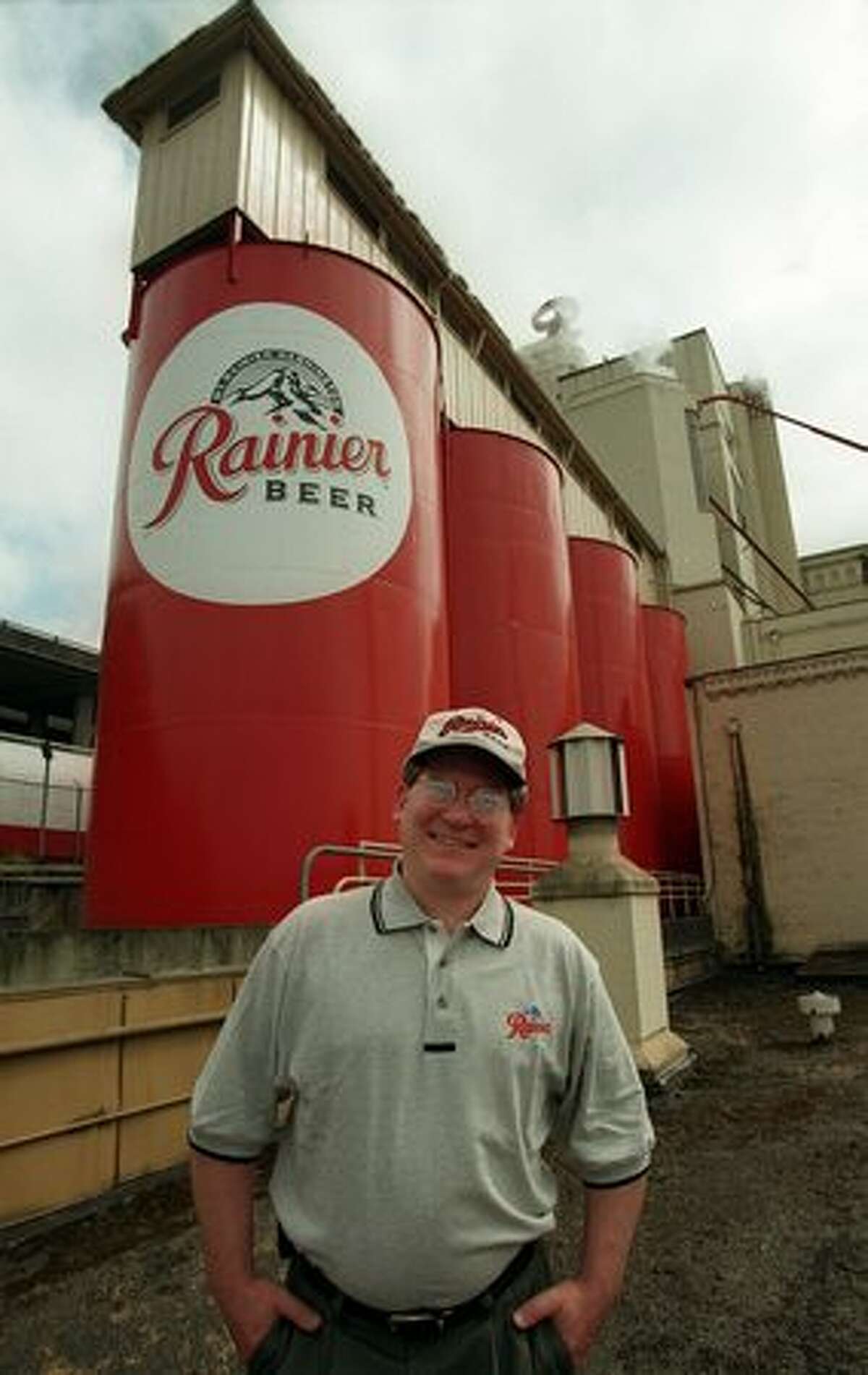The May 1998 photo caption read: Joe Thorner, Master Brewer at Rainier Beer, in front of the holding tanks at the plant on Airport Way. Rainier Brewing and it's corporate parent Stroh are making more than a half million dollars of investment in the Airport Way brewery to handle contract and specialty brewing.