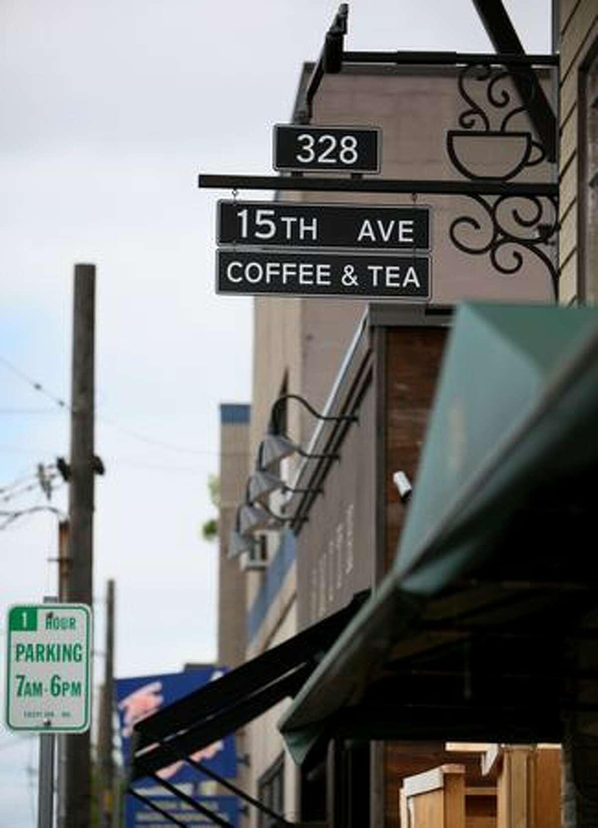 The sign of Starbucks' new 15th Avenue Coffee & Tea blends into the streetscape in Seattle's north Capitol Hill. The store is part of a project where Starbucks is trying to rebrand stores to blend into neighborhoods and be more of a community gathering place. The store opens for business on Friday, July 24.