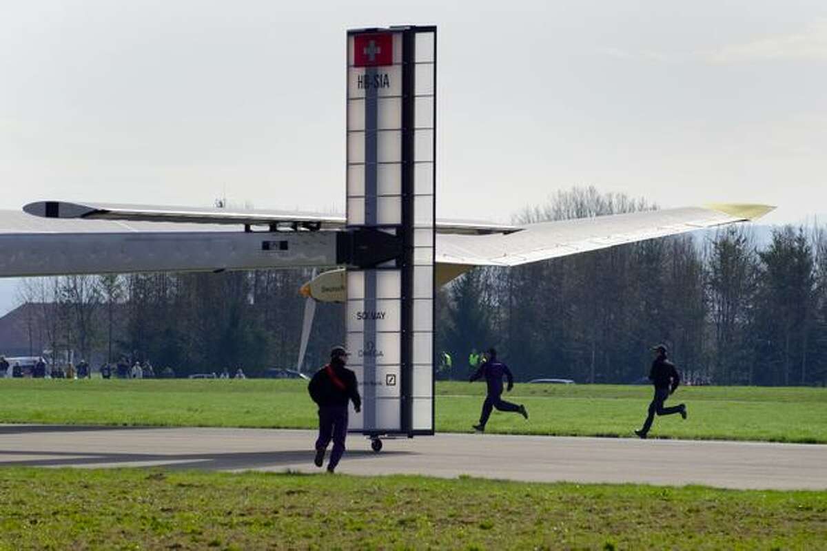 Staffers run behind the tail of the Solar Impulse aircraft, a pioneering Swiss bid to fly around the world on solar energy, takes off on its first test flight on April 7, 2010 from Payerne's air base, western Switzerland.