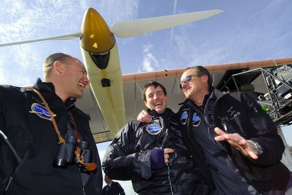 (From left) Swiss scientist-adventurer and pilot Bertrand Piccard, test pilot Markus Scherdel and Solar Impulse Chief Executive Andre Borschberg celebrate after the first test flight of Solar Impulse aircraft on April 7, 2010 from Payerne's air base, western Switzerland.
