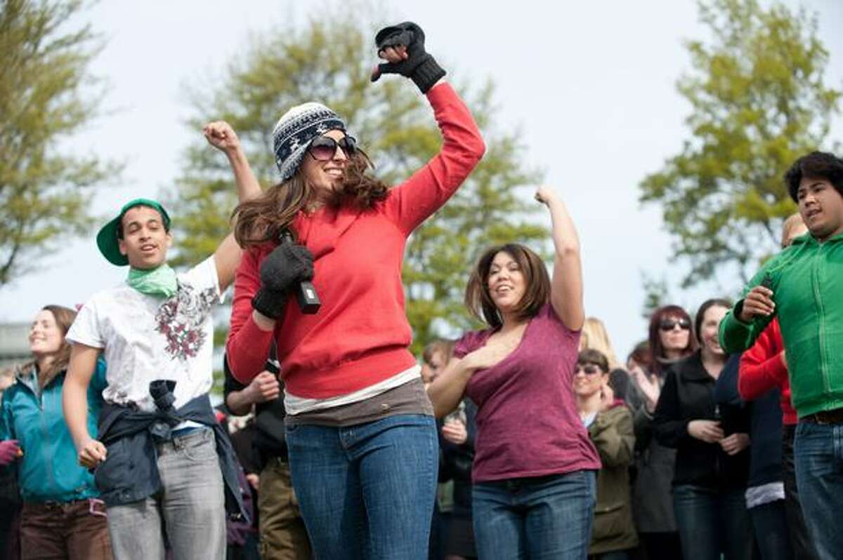 Beth Meberg, center, teaches the crowd the choreography to a rendition of "Somebody to Love." During a flashmob on April 10, 2010 in Seattle, over 1,000 "Gleeks" paid tribute to the show with a synchronized dance performance.