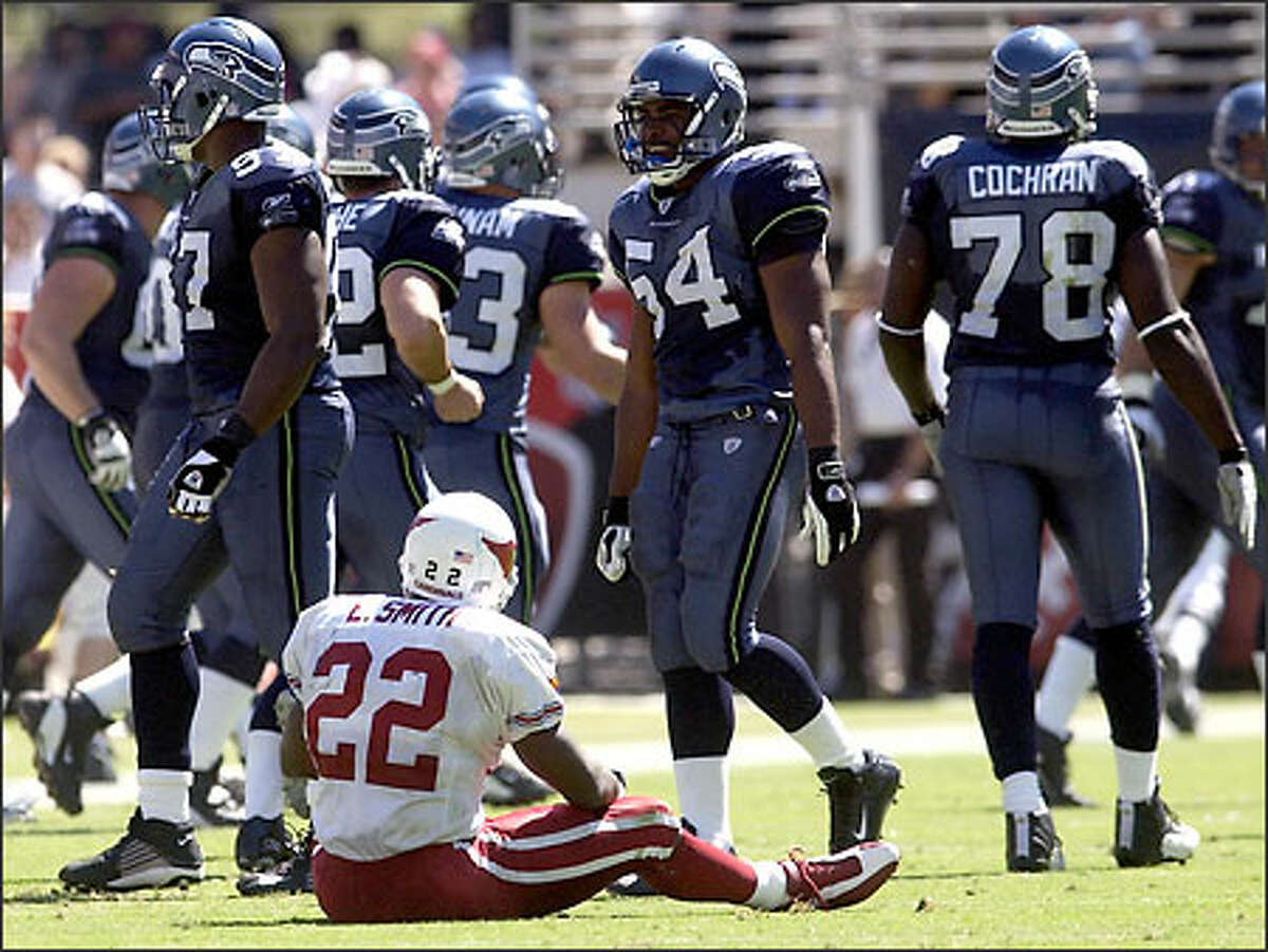 Cardinals running back Emmitt Smith watches the Seahawks defense leave the field after Smith fumbled during the second quarter. Smith was held to 54 yards on 14 carries.