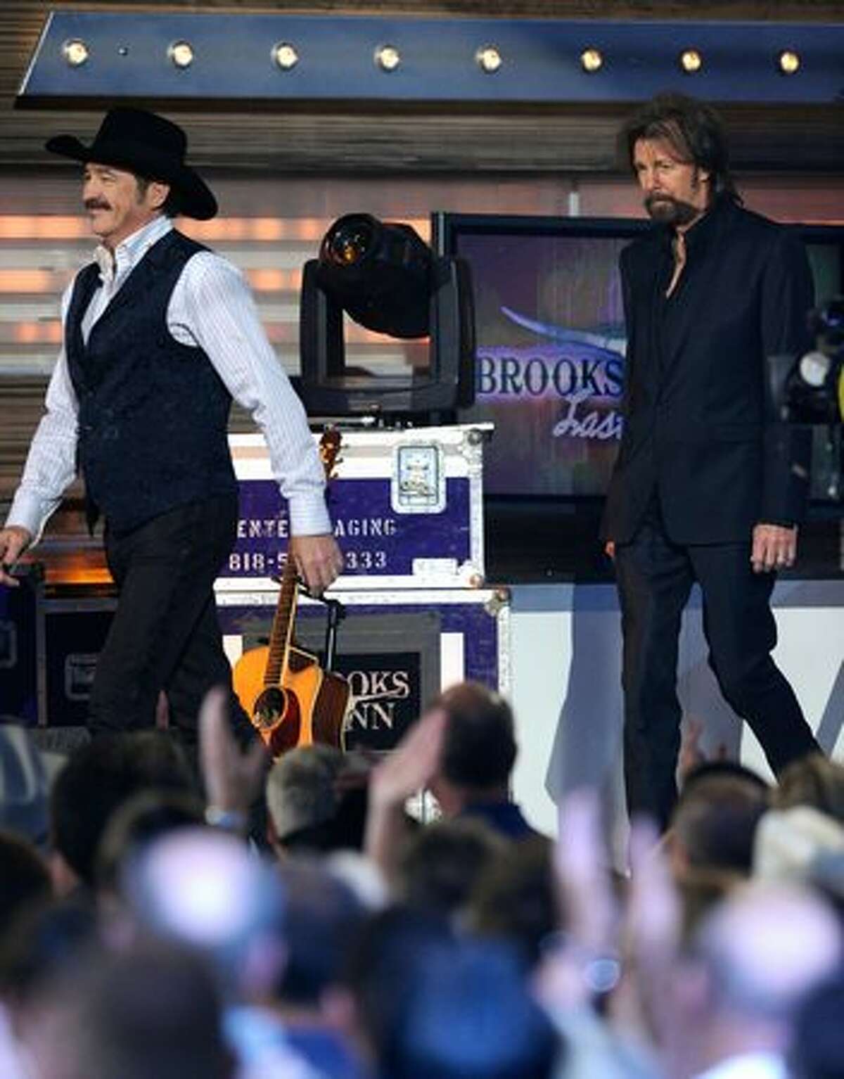Musicians Kix Brooks (left) and Ronnie Dunn of the band Brooks & Dunn walk onstage.