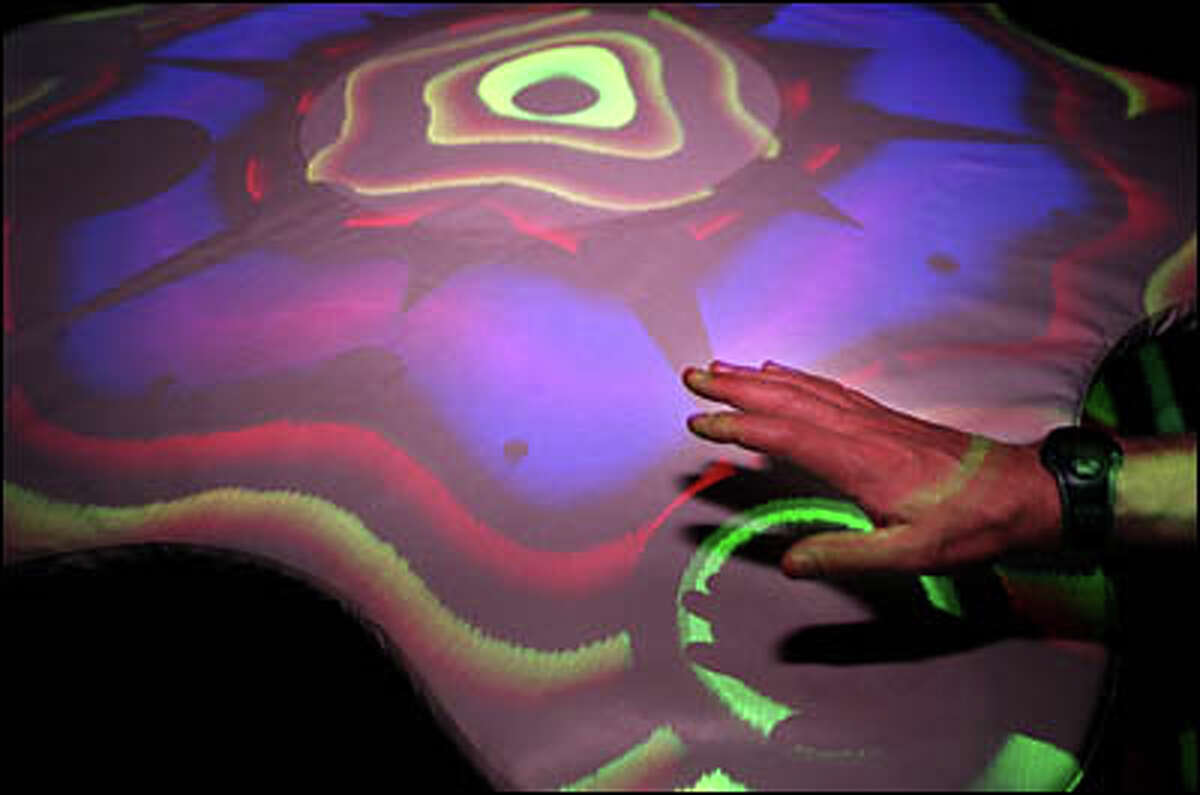 In the center of the Sound Lab stands a giant drum table called the Jam-O-Drum. Twelve people can join in, pounding different areas of the large surface as synchronized psychedelic graphics project onto the table and ceiling.