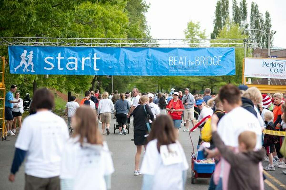 Participants gather outside of Husky Stadium to register and warm up before the annual Beat the Bridge fundraiser on Sunday, May 16, 2010 in Seattle.