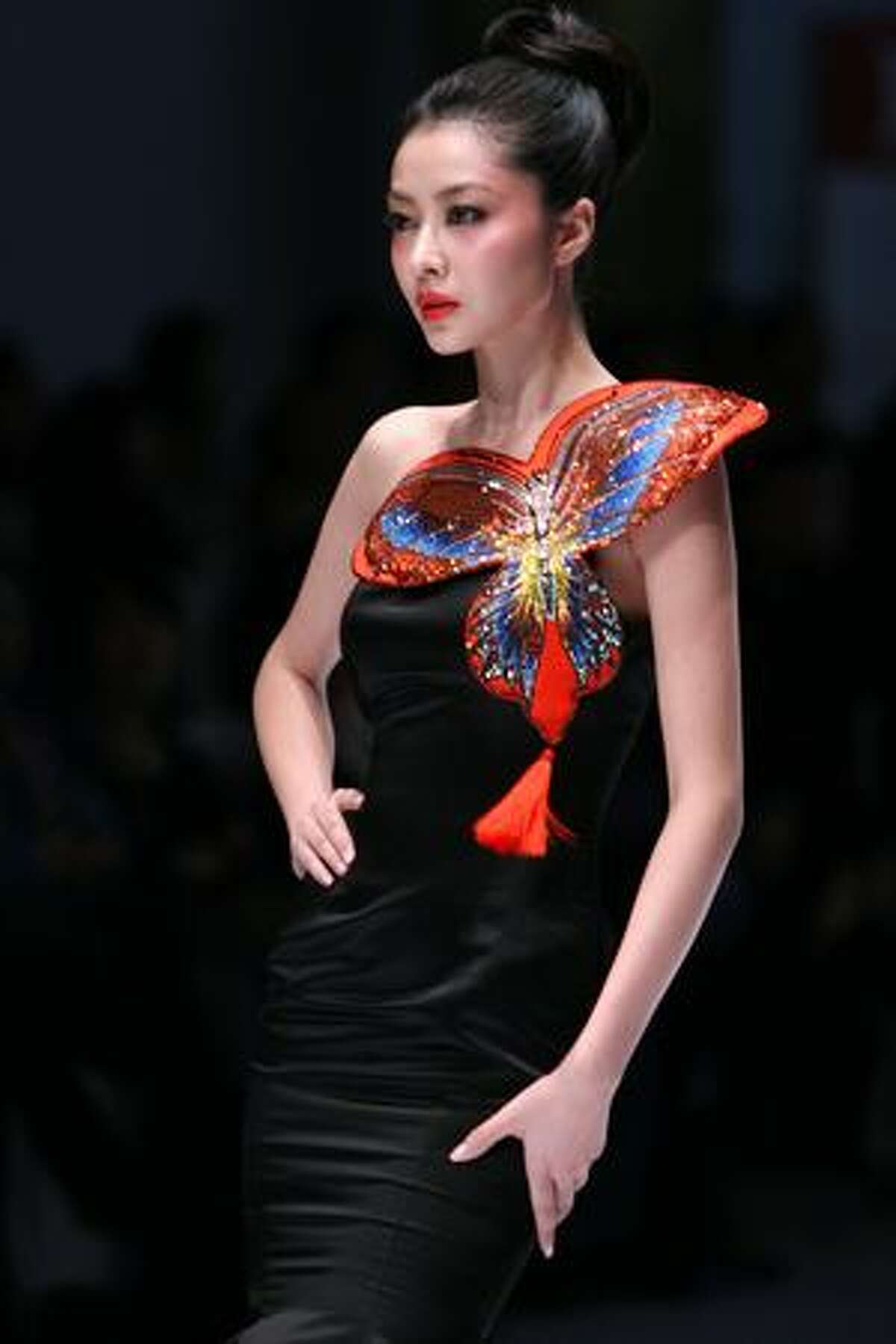 A model displays a creation from the NE TIGER Haute Couture Collection during the China Fashion Week in Beijing.