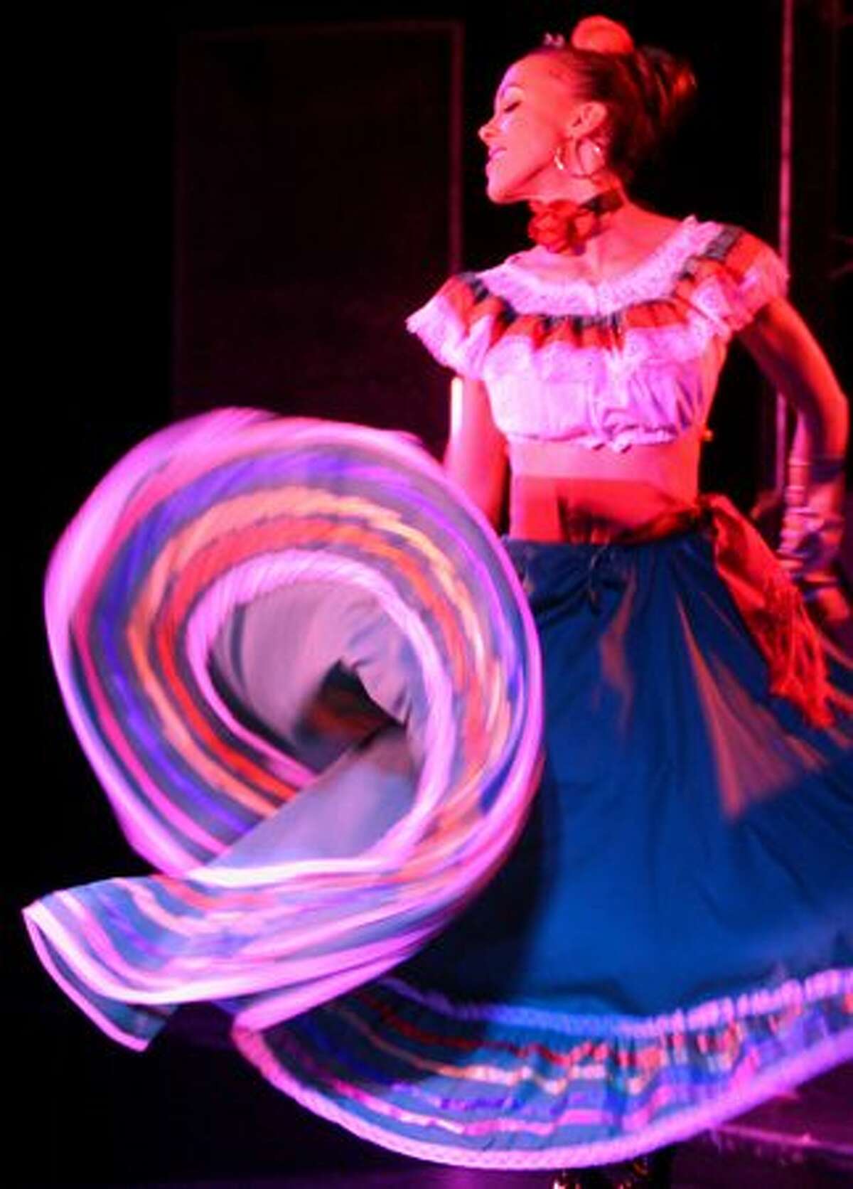 A dancer twirls her dress during a performance of Lucha VaVOOM at the Showbox Sodo on Sunday May 16, 2010. Lucha VaVOOM is a combination of Mexican wrestling, burlesque and comedy.