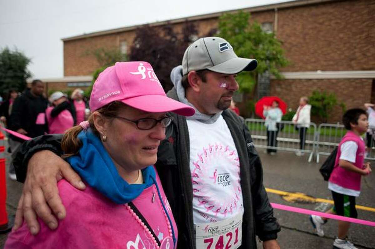 Husband and wife cross the finish line together during the 17th Annual Komen Puget Sound Race for the Cure in Seattle on June 6, 2010.