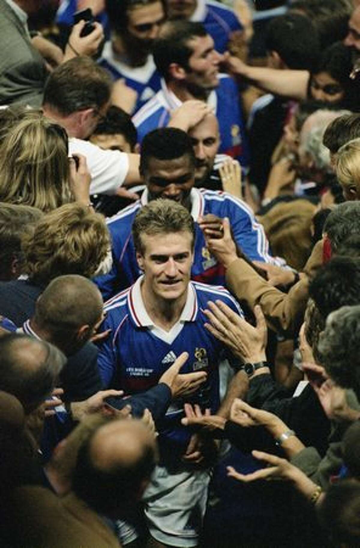 1998: France captain Didier Deschamps leads his team up to the presentation box after victory in the World Cup final against Brazil.