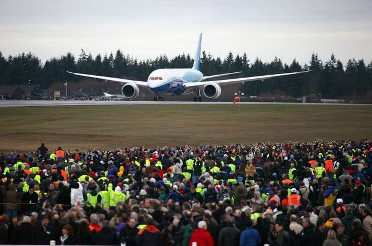 Boeing's 787 Dreamliner taxis down the runway before taking off on its maiden flight.