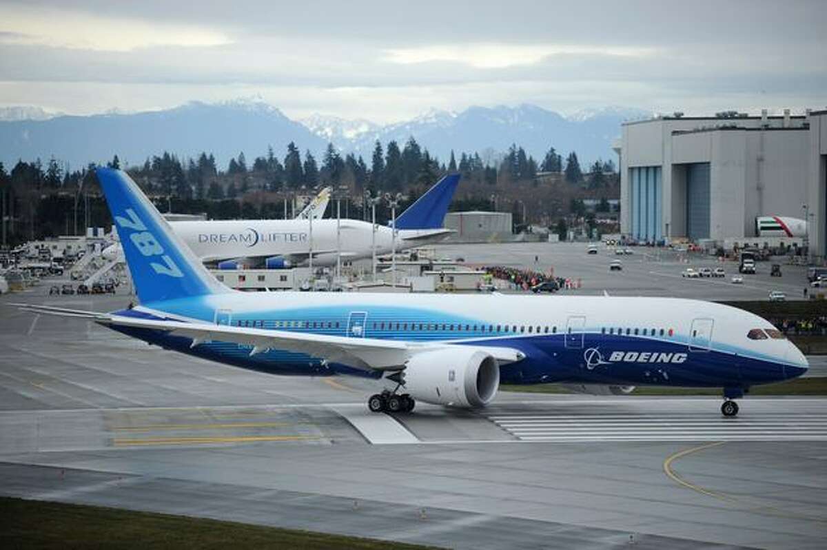 Boeing's 787 Dreamliner taxis down the runway to make its first flight at Paine Field in Everett.