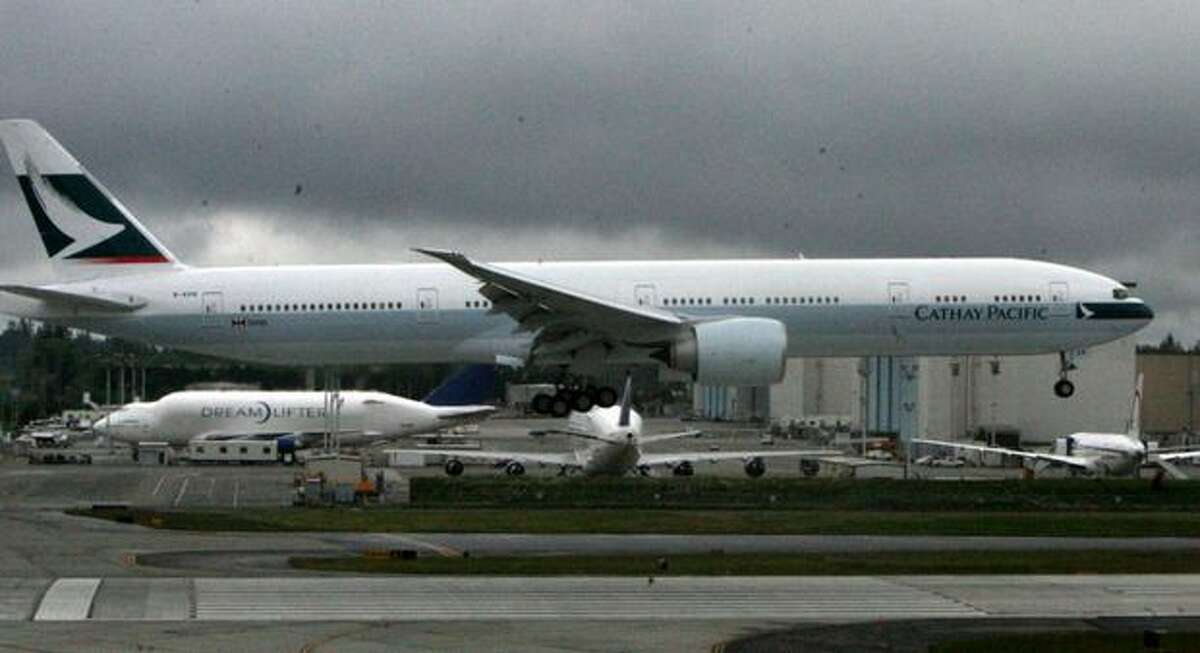 A Cathay Pacific Boeing 777 lands at Paine Field, in Everett.