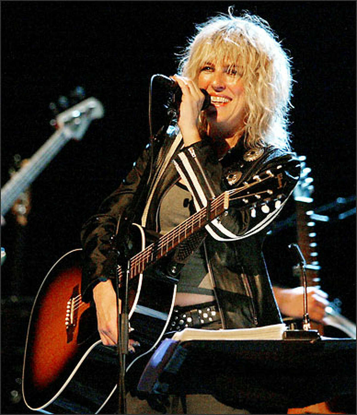 Lucinda Williams invited the audience at The Moore to come down to the stage and dance, and when they did, she said, "Now we've turned this place into a rock club."