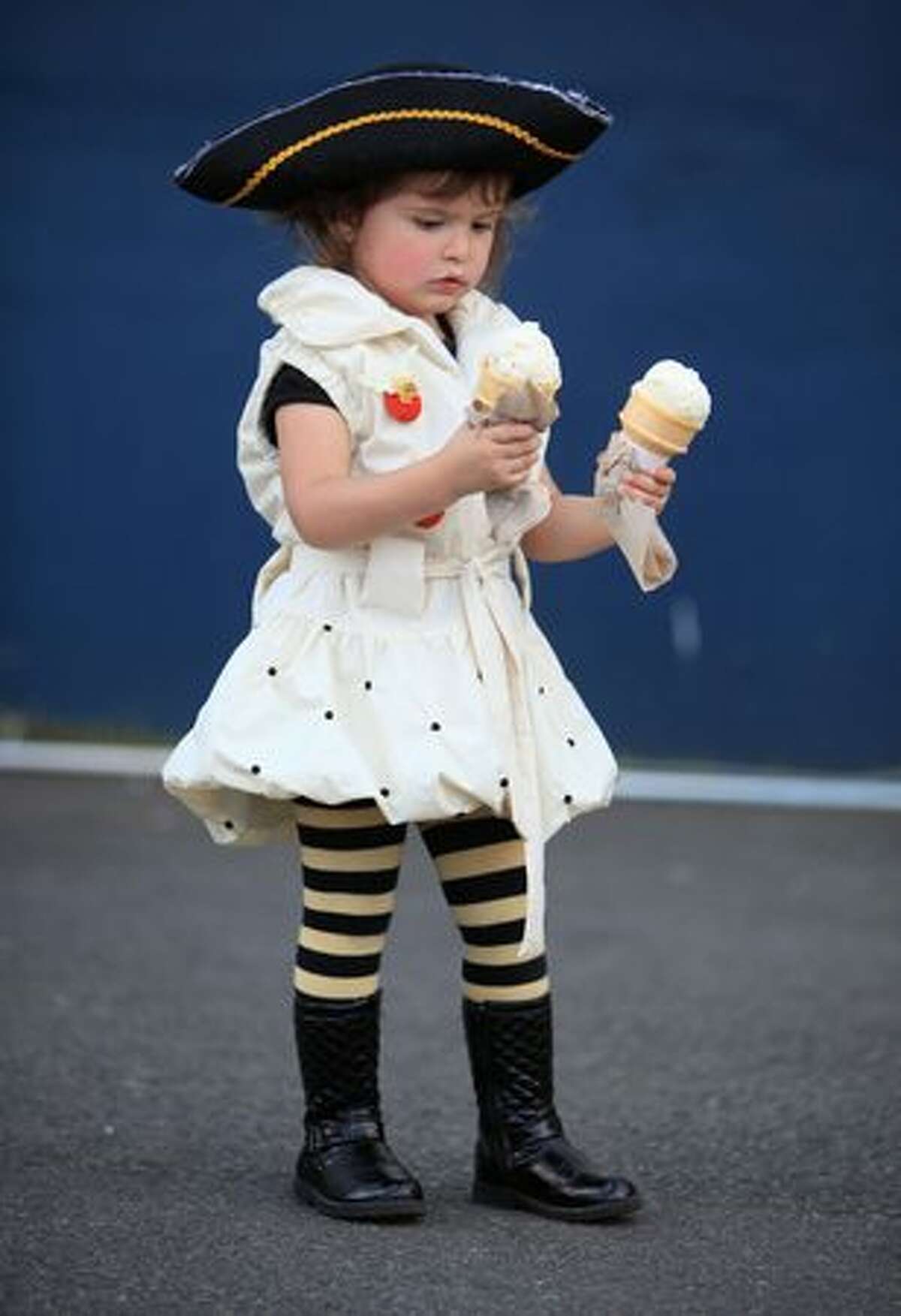 Layla Noel, 2, holds onto a pair of ice cream cones during the Lake Union Wooden Boat Festival.