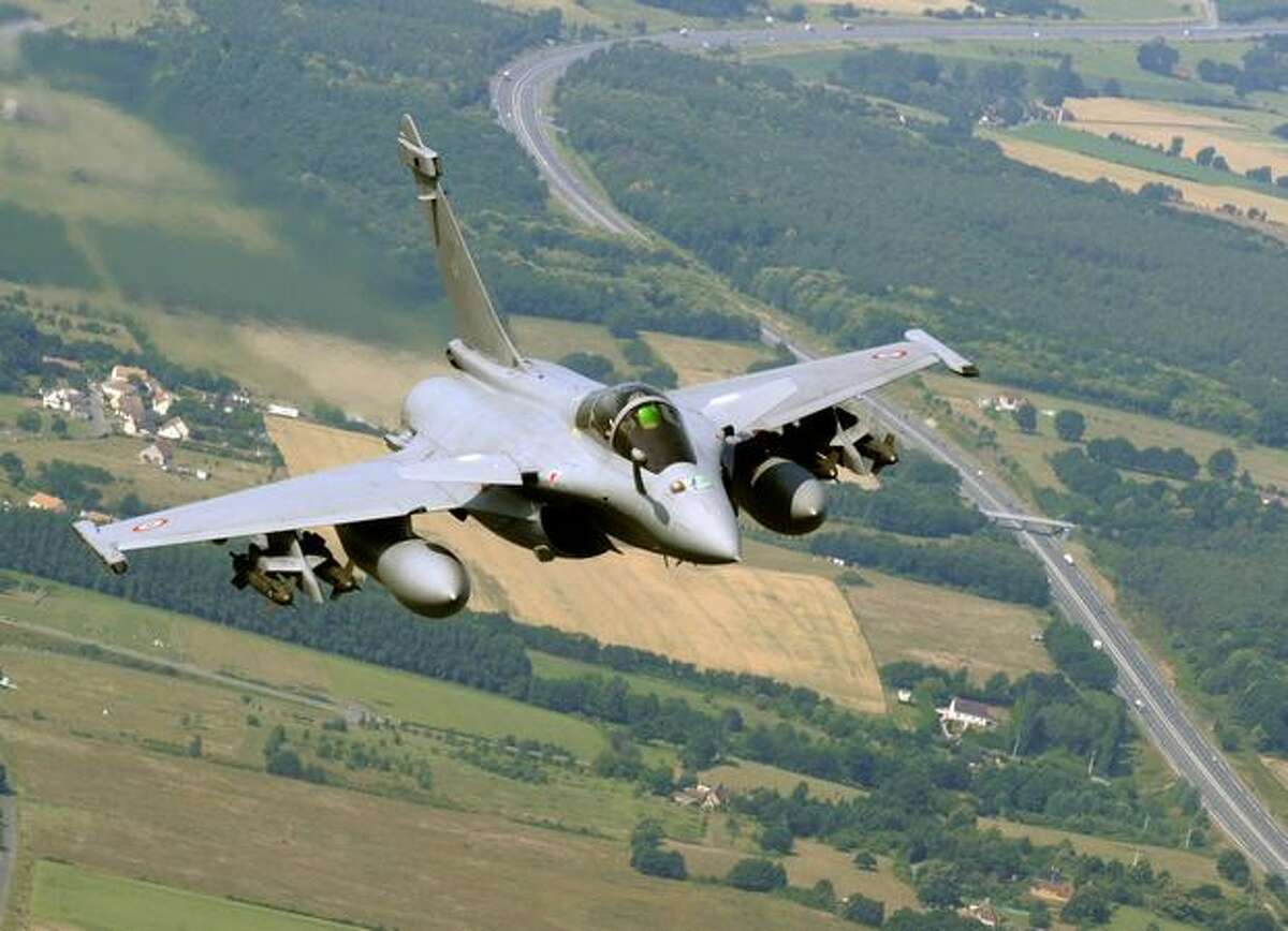 A picture taken aboard a Boeing C-135 Stratolifter over Chateaudun, France shows a Rafale fighter jet on a training flight ahead of the July 14 Bastille Day military air parade in Paris.