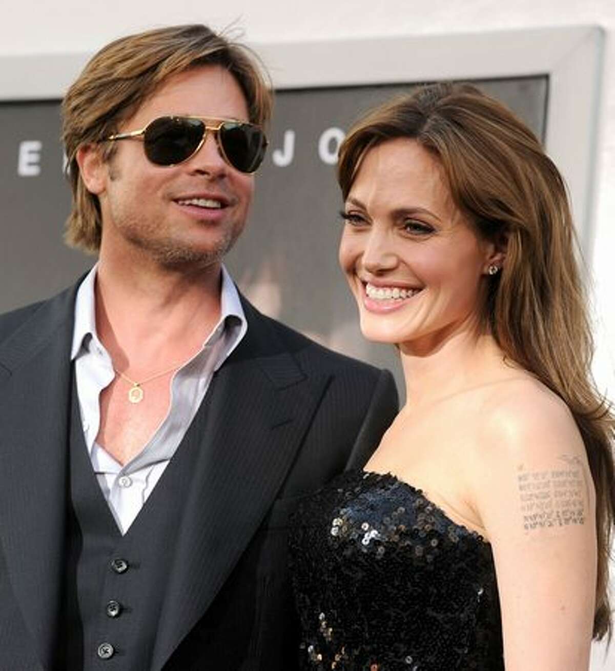 Actor Brad Pitt (L) and actress Angelina Jolie arrive.