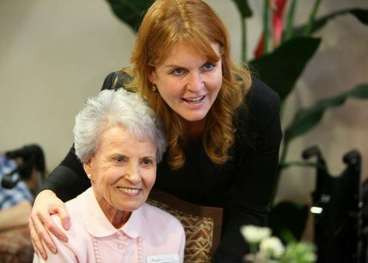 Sarah Ferguson, the Duchess of York, has her photo taken with Mary Sarich during a visit to Aegis Living of Shoreline.