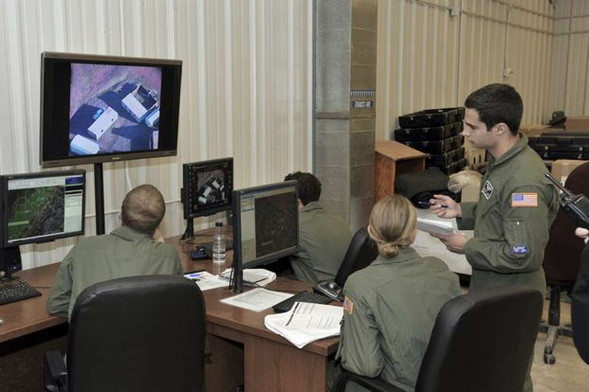 Air Force Academy cadets control the flight of a Scan Eagle, a remotely piloted aircraft built by Boeing subsidiary Insitu, at Fort Carson, Colo.