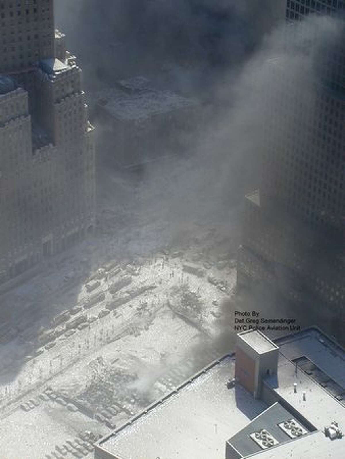 This photo taken Sept. 11, 2001 by the New York City Police Department and obtained by ABC News in 2010, which claims to have obtained it under the Freedom of Information Act, shows white ash covering the downtown area near the grounds of the World Trade Center in New York. (AP Photo/NYPD via ABC News, Det. Greg Semendinger)