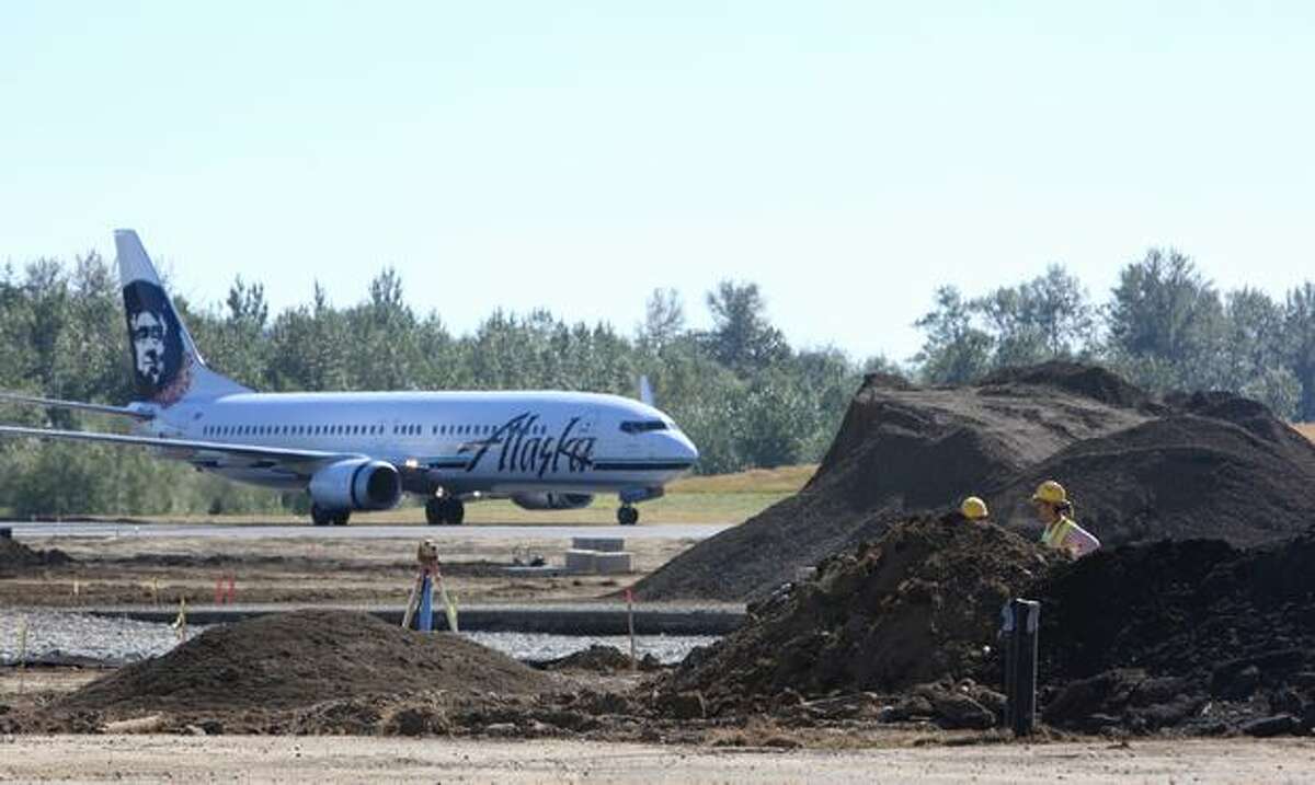 An Alaska Airlines plane taxis next to one of the construction projects underway at Bellingham International Airport. The Whatcom County airport is raising its profile with major construction projects and upgrades. A buzz was created recently when Alaska started offering direct flights from Bellingham to Hawaii.