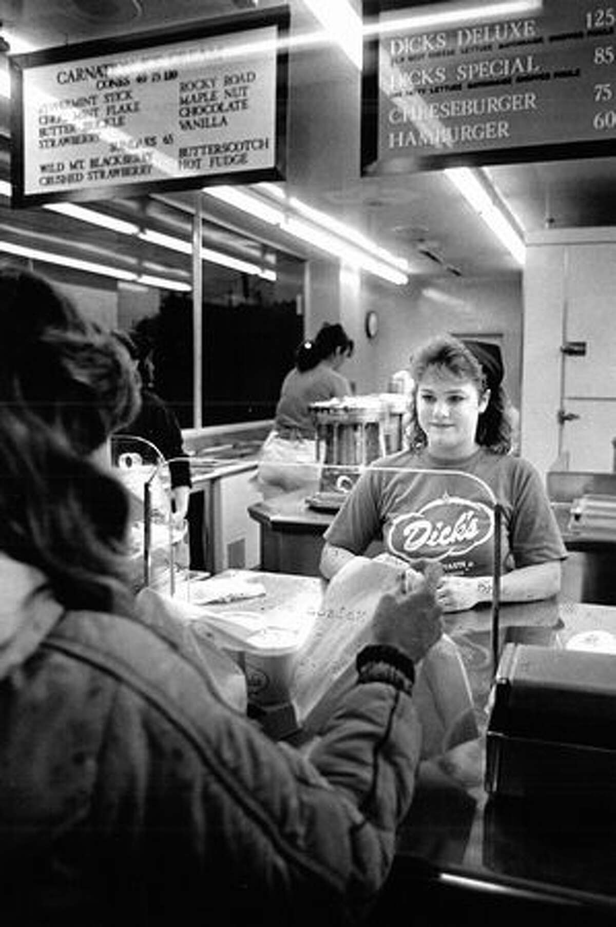 Debbie Dahms gives a customer her order during an after-school shift, March 1986. (Seattlepi.com file)