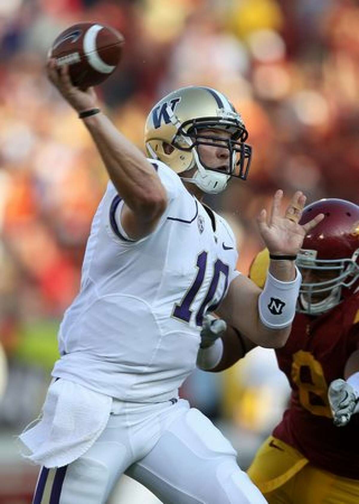 Quarterback Jake Locker #10 of the Washington Huskies throws a pass against the USC Trojans at the Los Angeles Memorial Coliseum on October 2, 2010 in Los Angeles, California.