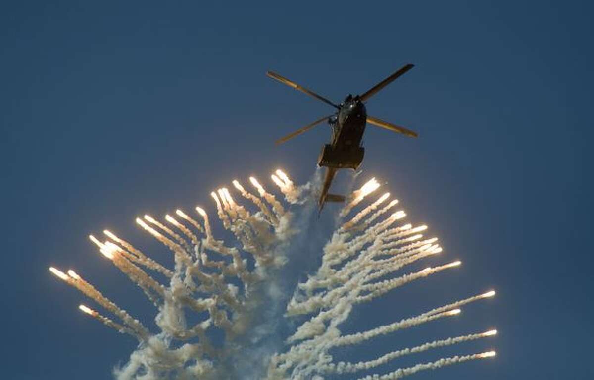 A South African Air Force Oryx helicopter fires flares during the Africa Aeronautics and Defence Airshow, at Ysterplaat Airforce Base in Cape Town, South Africa.