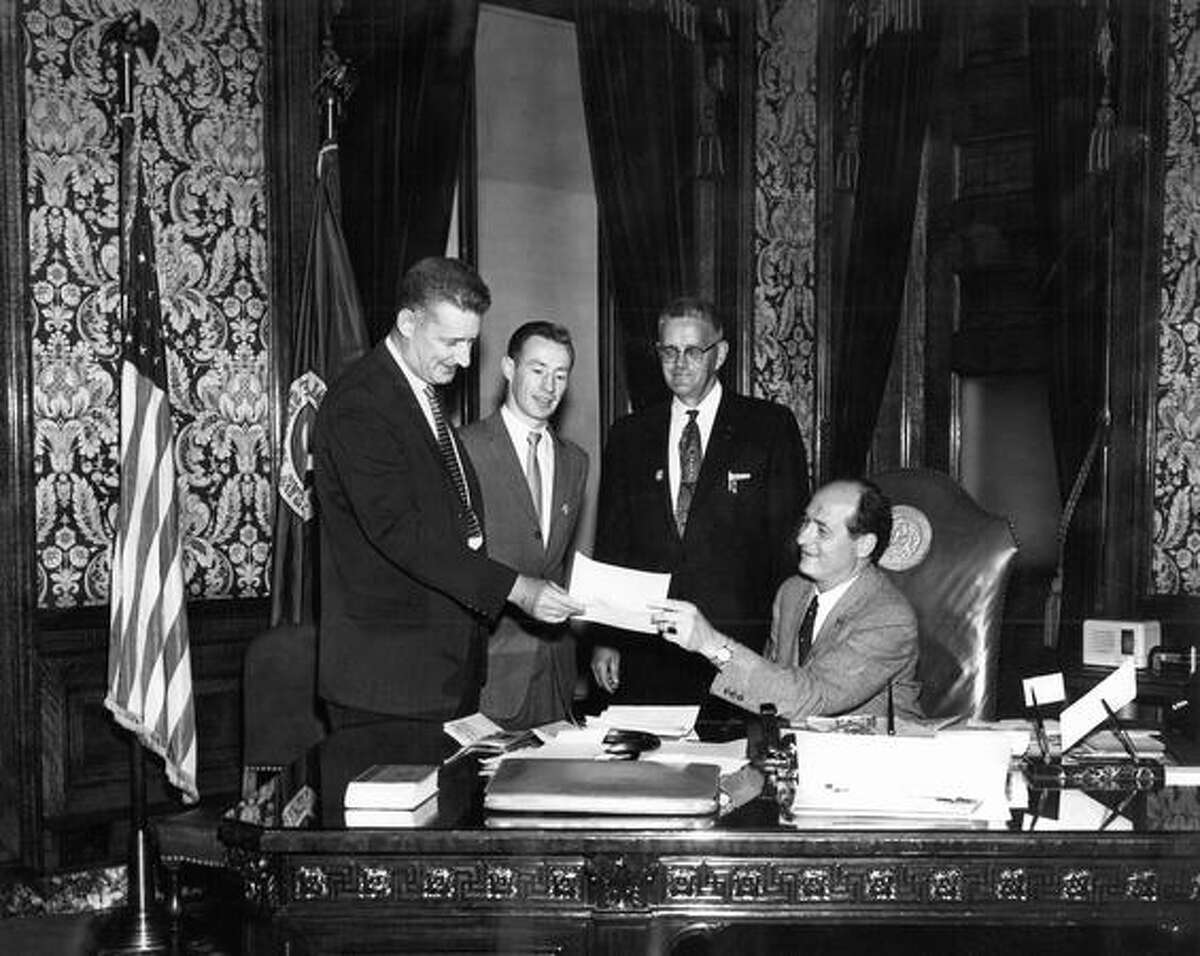 Governor Al Rosellini presents his signed proclamation to three members of the Washington State Apprenticeship Council, left to right: Ed Haynes, Don MacPherson, Wallace Y. Armstrong and Governor Albert D. Rosellini. June 5, 1958.