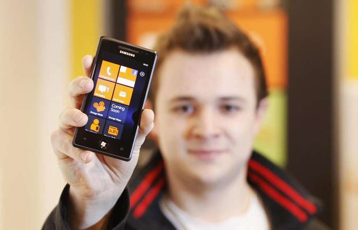 Andrew Willett, 22, of London gets his hands on the first Windows Phone 7 at the Orange Shop Oxford Street on Thursday in the English capital. (David Parry/PA Wire)