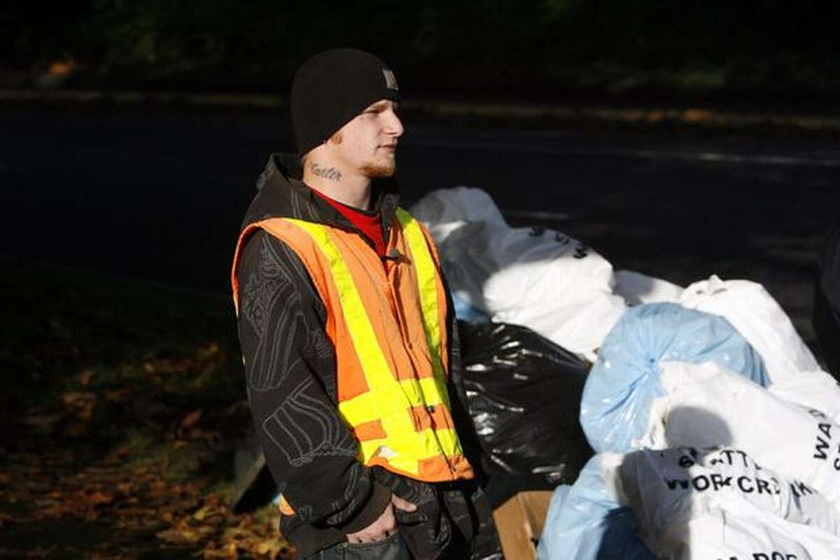 Thomas Abuhl, part of a Department of Corrections offender work crew, collects waste near South Columbian Way and South Alaska Street in Seattle. The 22-year-old, who was serving 256 hours for an assault case, said he appreciated the opportunity.