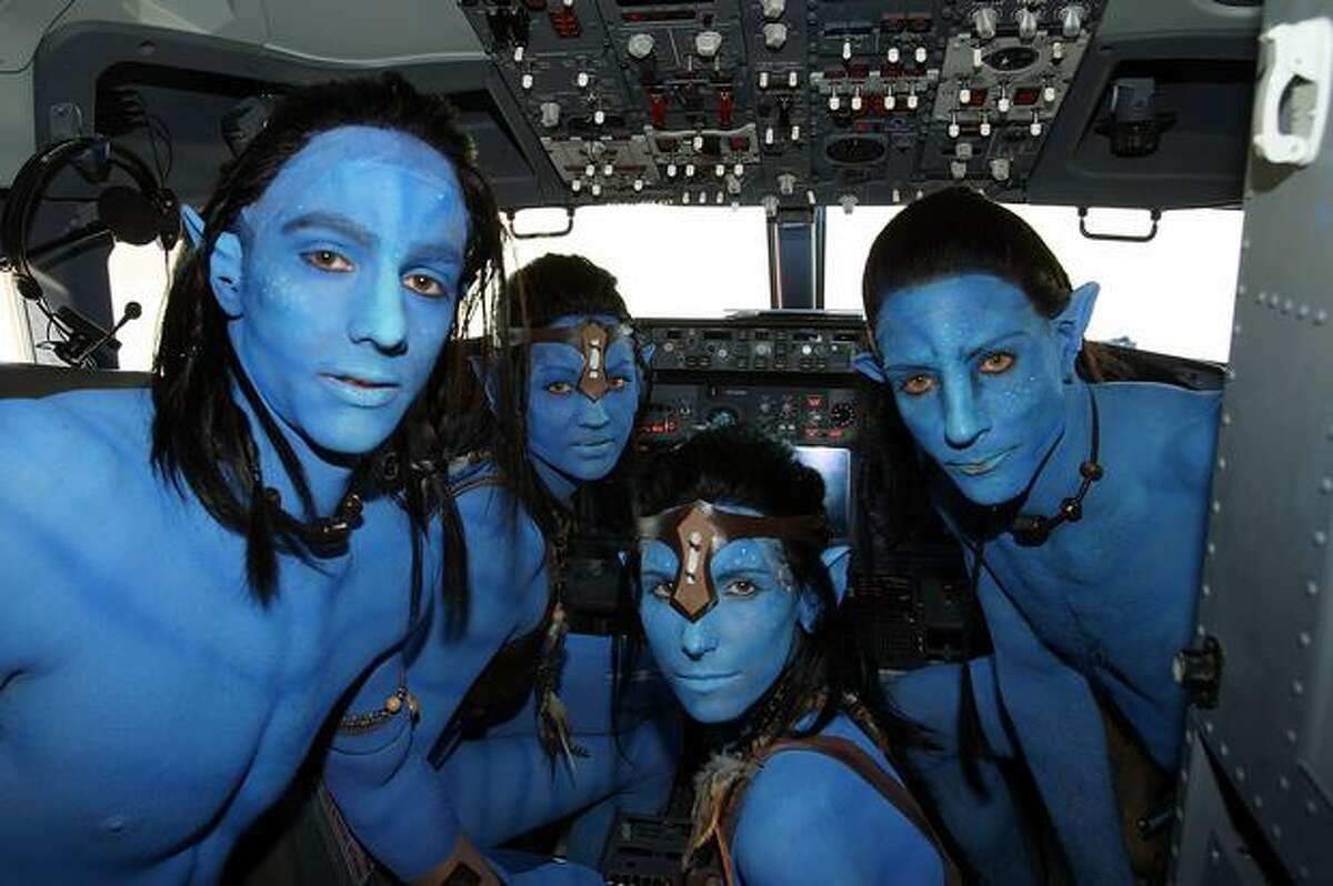 Models dressed up as characters from the film "Avatar" pose in the cockpit of an Avatar-themed Virgin Blue Boeing 737 during the launch of "Avatar" Blu-ray and DVD at Sydney Domestic Airport, in Sydney, Australia.