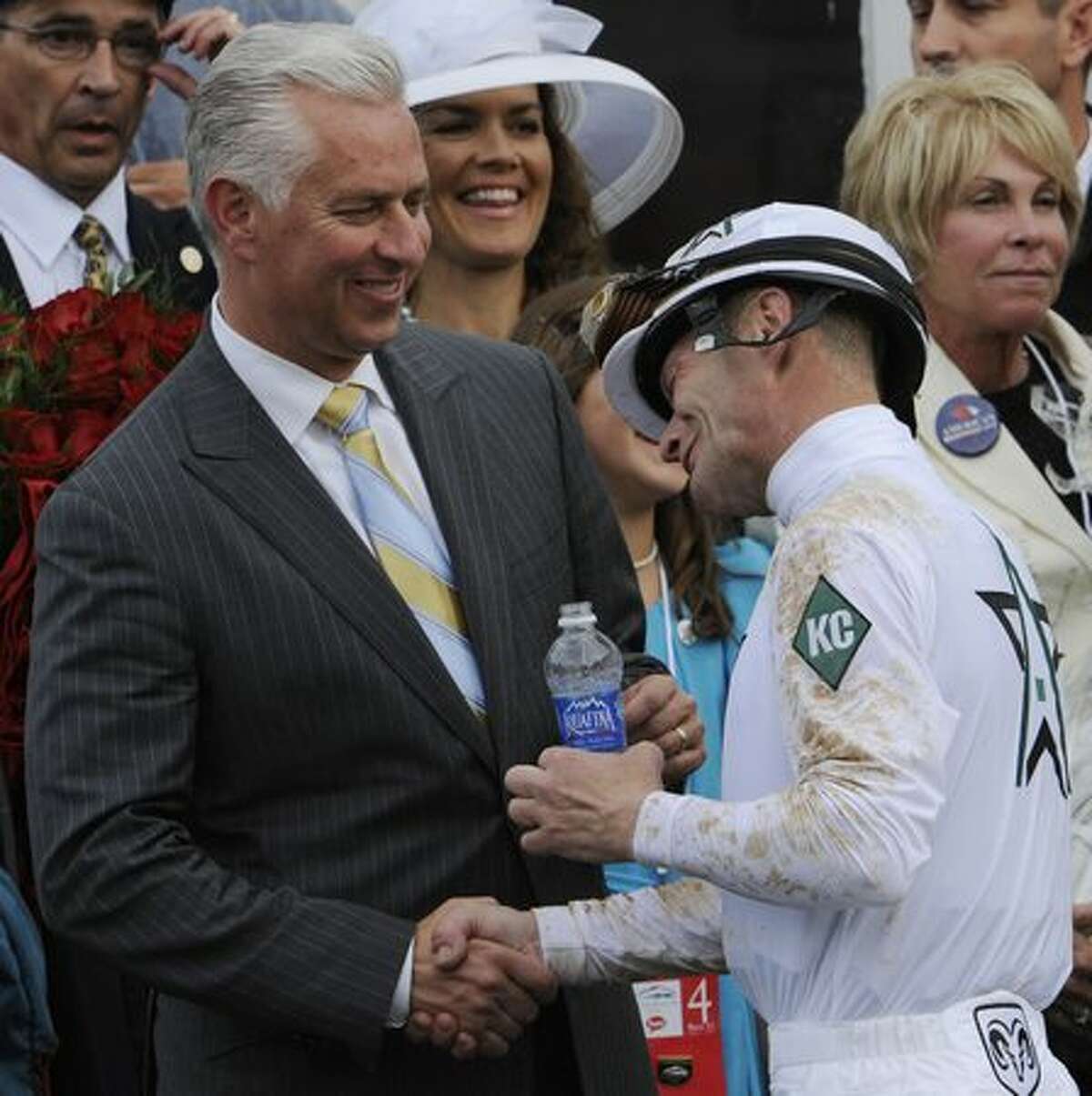 Jockey Calvin Borel is congratulated by Trainer Todd Pletcher after his first win and Borel's third Kentucky Derby win on Super Saver at Churchill Downs in Louisville, Kentucky May 1, 2010. (Skip Dickstein / Times Union)