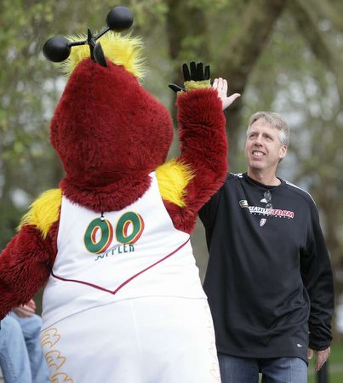 Seattle Storm coach Brian Agler high-fives mascot Doppler during the team's "Stormin' the Lake" fan event at Green Lake Park in Seattle on Saturday May 1, 2010. The season begins on May 16th with a game against Los Angeles. The Storm also host a preseason game on Sunday May 2nd against Phoenix.