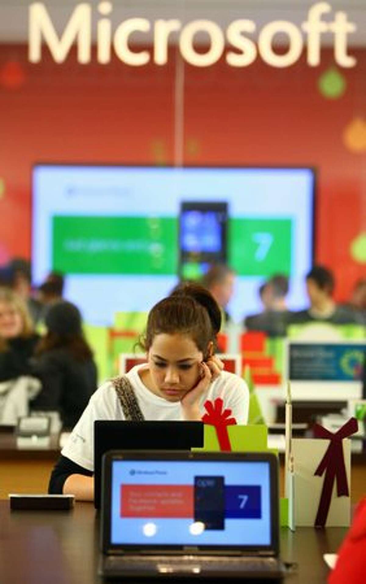 Jessica Hill of Seattle looks at a laptop during the opening of the first first local Microsoft Store on Thursday at Bellevue Square mall.